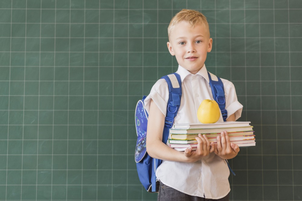 boy-with-backpack-books-near-blackboard.jpg