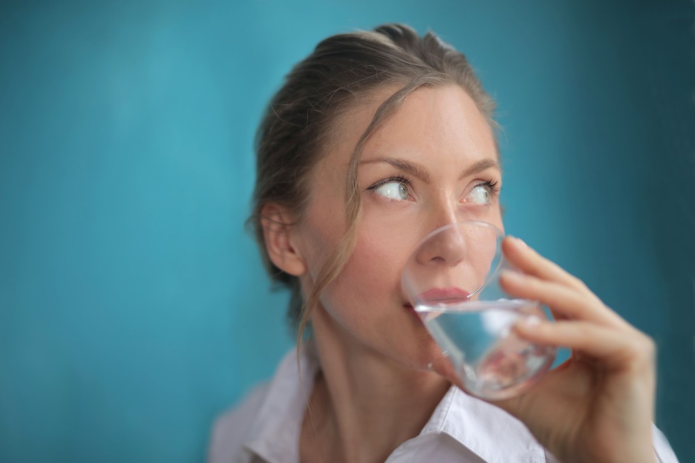 closeup-shot-pretty-female-drinking-water-blue.jpg
