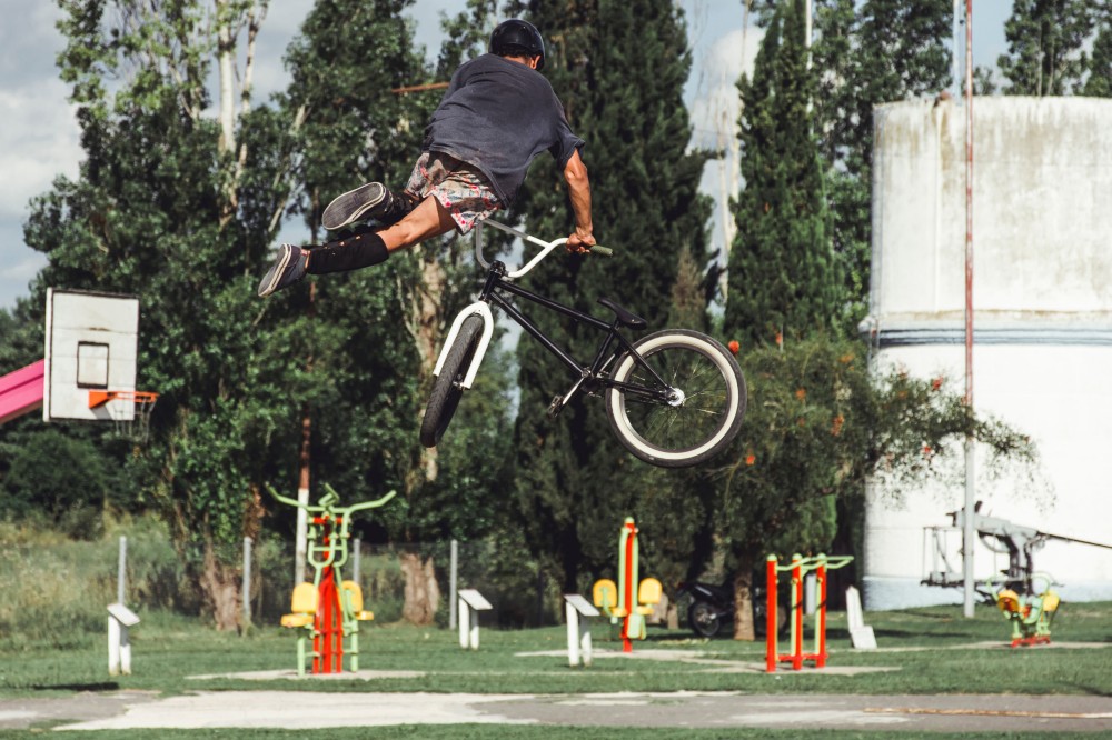 rear-view-boy-with-amazing-bicycle-stunt-skate-park.jpg